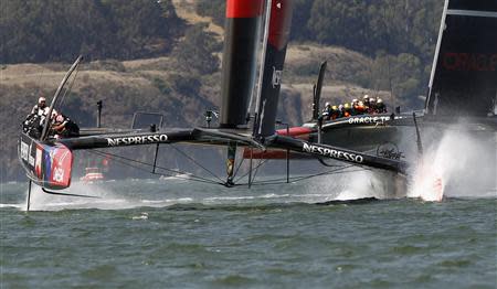 Emirates Team New Zealand (L) gets to the first mark ahead of Oracle Team USA during Race 7 of the 34th America's Cup yacht sailing race in San Francisco, California September 12, 2013. REUTERS/Robert Galbraith