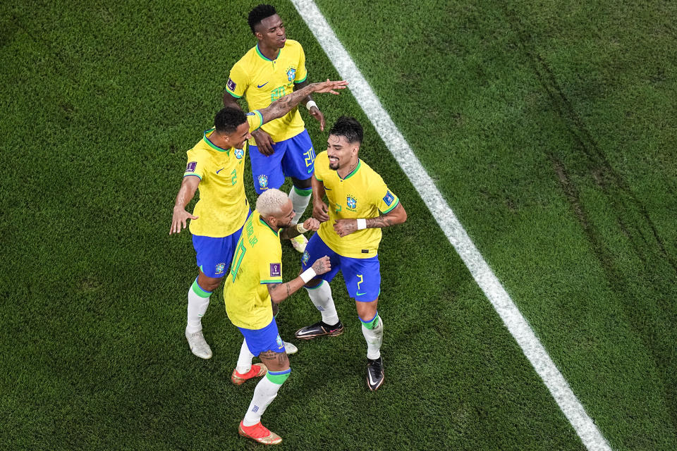 Image: Brazil's Vinícius Júnior, Danilo and Neymar dance with Lucas Paquetá, right, after he scored his side's fourth goal during the World Cup round of 16 soccer match between Brazil and South Korea in Al Rayyan, Qatar, on Dec. 5, 2022. (Pavel Golovkin / AP)