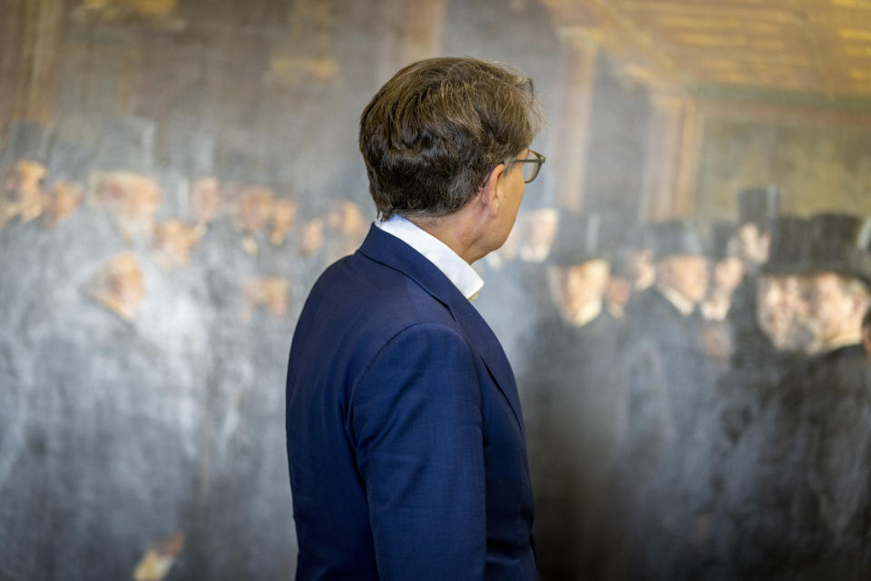 CEO of Dansk Erhverv Brian Mikkelsen looks at artworks saved from Boersen during the fire, at the National Museum's warehouse in Vinge, Denmark, on Tuesday, June 4, 2024. Boersen, in Copenhagen, caught fire on April 16, 2024. More than 300 art objects were saved from the burning building. (Ida Marie Odgaard/Ritzau Scanpix via AP)