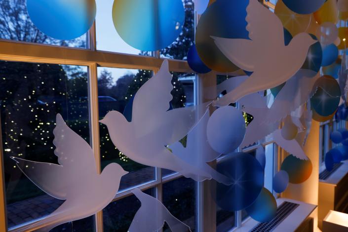 Dove cutouts by a window, part of Christmas decorations in the East Colonnade of the White House in 2021.