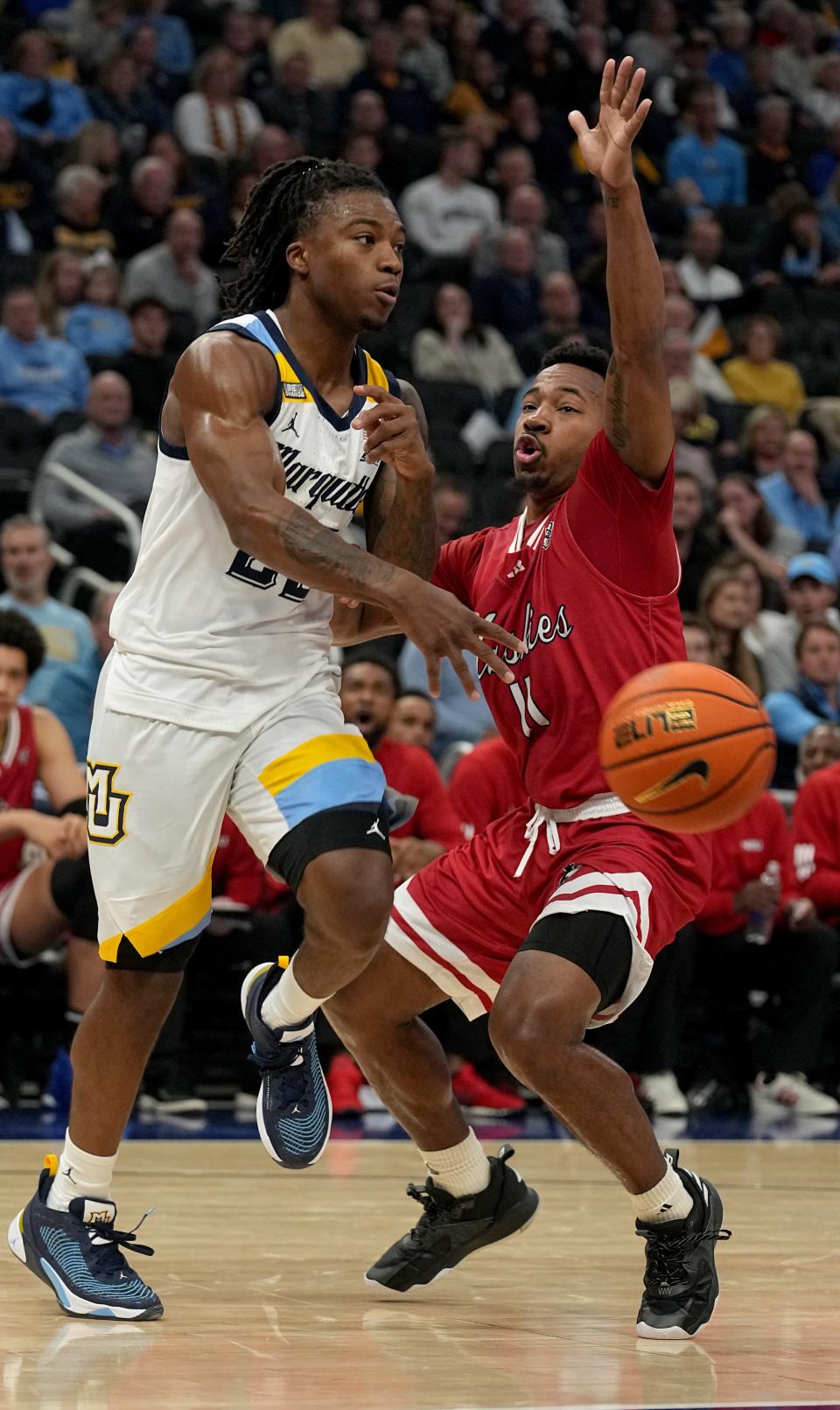 FILE - Marquette guard Sean Jones (22) passes the ball to then-Northern Illinois guard David Coit (11) during the first half of a game on Nov. 6, 2023 in Milwaukee, Wisconsin.