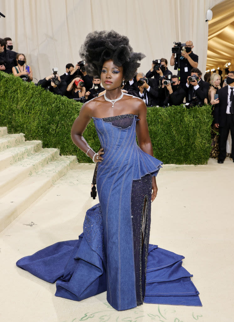 Lupita Nyong'o wears a long denim strapless gown