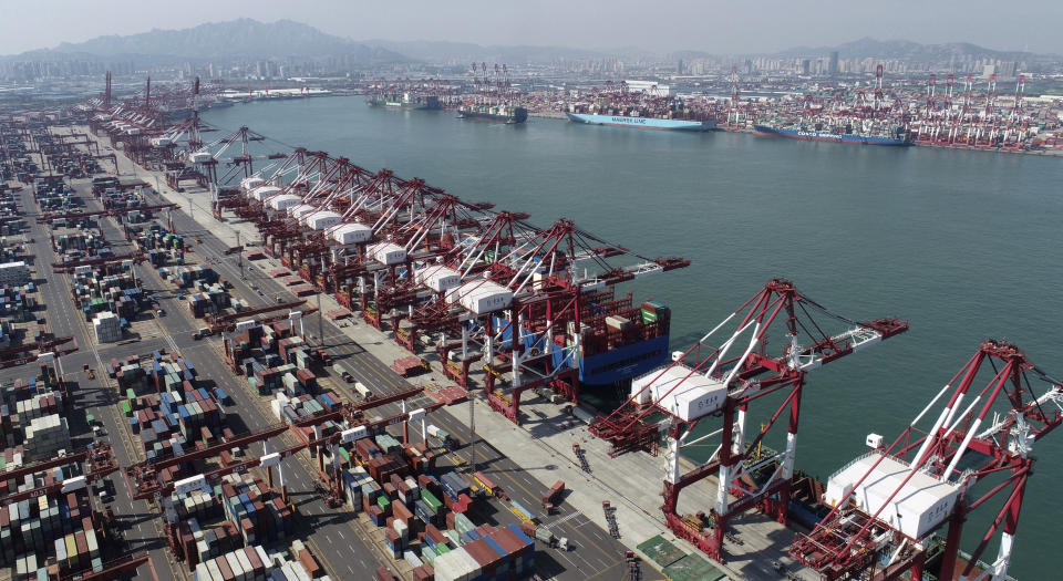 Container ships are docked at a container port as seen in an aerial photo in Qingdao in eastern China's Shandong Province, Thursday, Oct. 8, 2020. China's trade growth accelerated in September as the world's second-largest economy recovered form the coronavirus pandemic. (Chinatopix via AP)