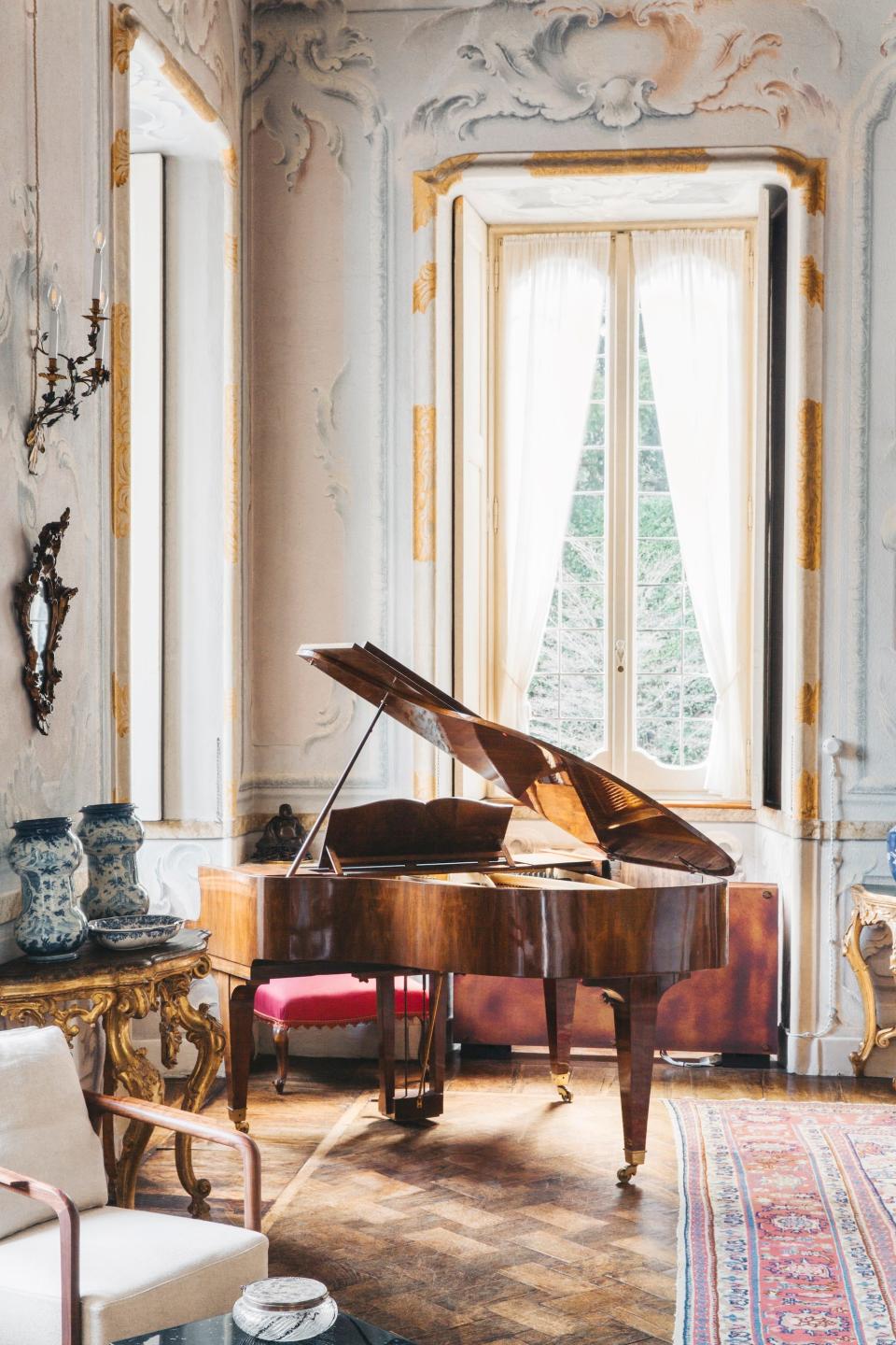 A villa with a grand piano inside of it.