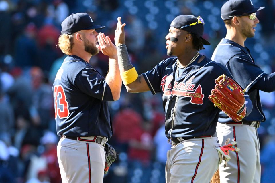 A.J. Minter and Ronald Acuña Jr. celebrate the opening day win against the Nationals.