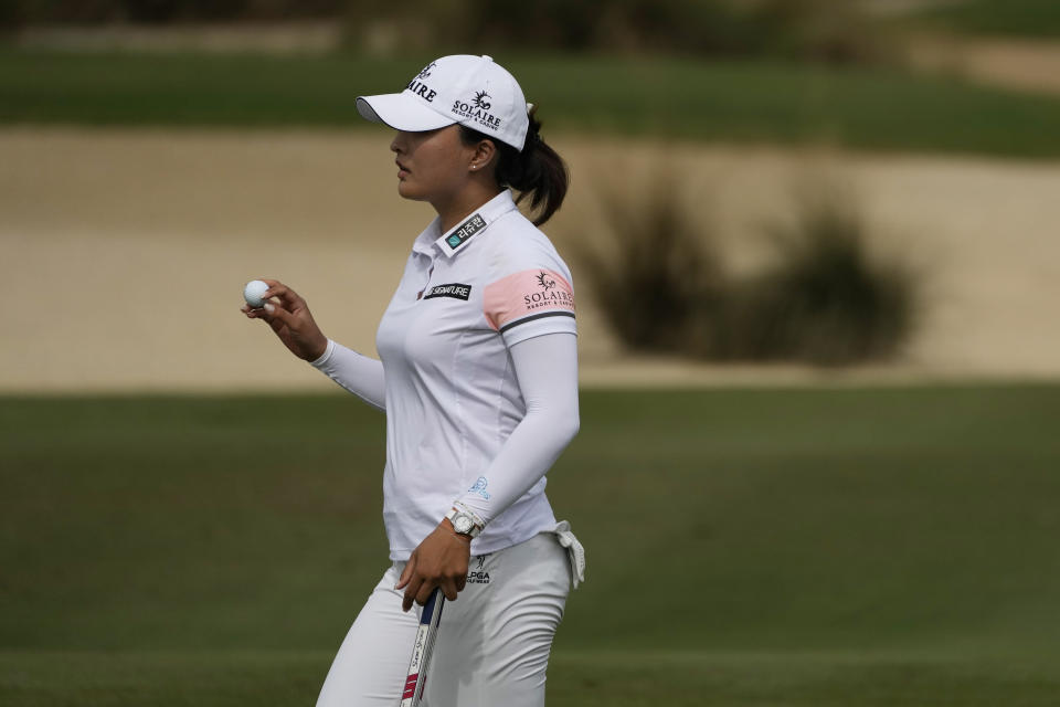 Jin Young Ko, of Korea, tips her ball to the gallery on the eighth hole during the final round of the LPGA Tour Championship golf tournament, Sunday, Nov. 21, 2021, in Naples, Fla. (AP Photo/Rebecca Blackwell)