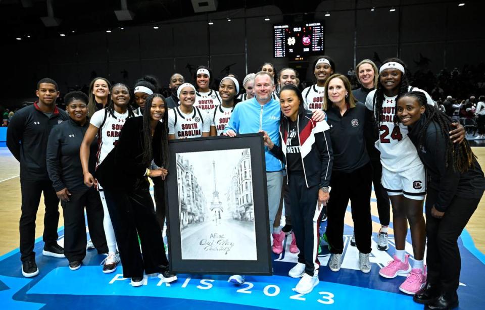 South Carolina Gamecocks players and staff pose for a photo after playing against the Notre Dame Fighting Irish in a women’s college basketball game at Halles Georges Arena.