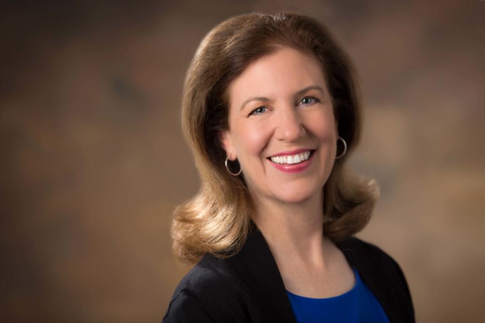 A woman smiles in a headshot.