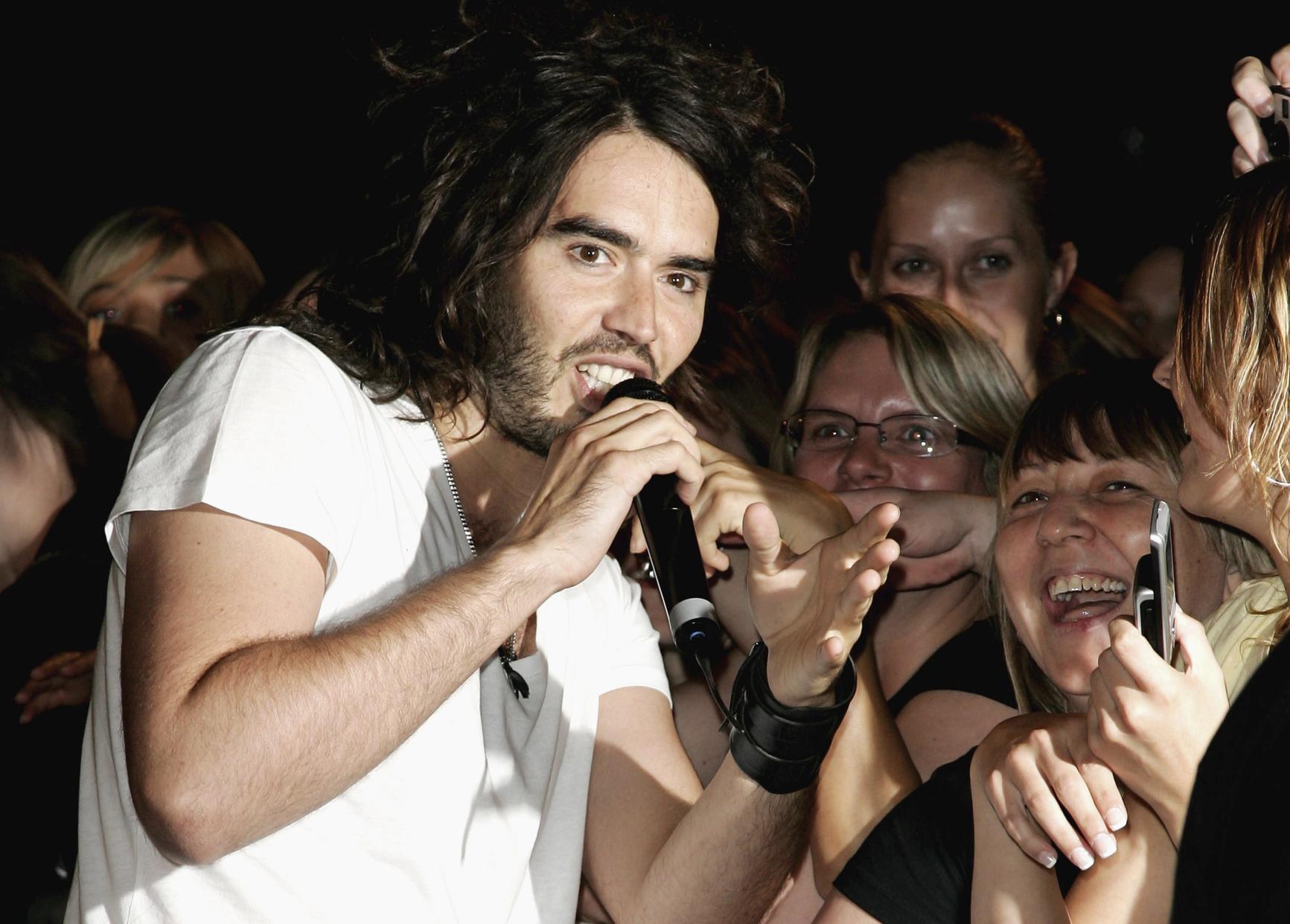 Russell Brand talks to fans outside the Big Brother Seven House on August 04, 2006 in Borehamwood, England.  (Photo by Gareth Cattermole/Getty Images)