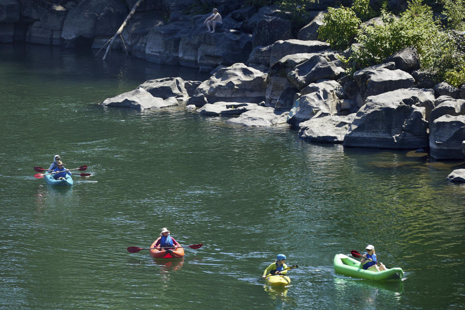 Kayakers paddle on the Clackamas River to escape from the heat during a record setting heat wave in Oregon City, Ore., Sunday, June 27, 2021. Yesterday set a record high for the day with more records expected today. (AP Photo/Craig Mitchelldyer)