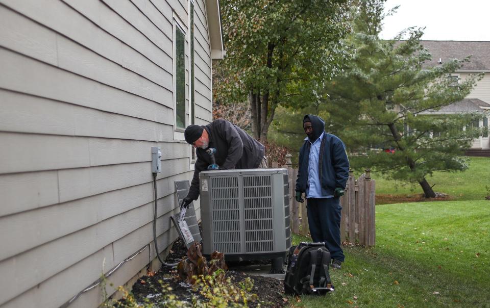 Hoosiers could likely pay up to $69 million more collectively for air conditioning costs after a recent study shows Indiana will face an increasing number of extreme heat days due to the warming effects of greenhouse gas emissions. In this photo, Marlon Jackson (right), an HVAC tech of five years, works with Mark Ridgeway, owner of M&B Heating & Air Conditioning in Fishers, to figure out the defect in a heat pump at a home in Fishers, Ind., on Friday, Nov. 16, 2018. Ridgeway, an HVAC tech of 43 years, started his own company one and a half years ago.