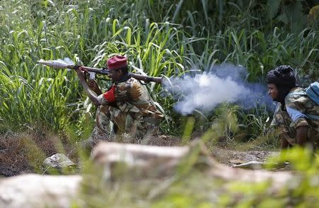 A Seleka fighter fires a rocket propelled grenade (RPG) towards French soldiers in Bambari May 24, 2014. REUTERS/Goran Tomasevic