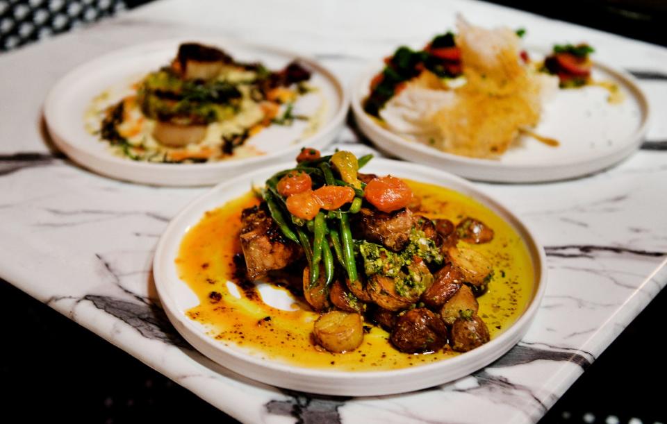 Smoked Bone-in Pork Chop with crispy confit potatoes, green beans and tomato salad is served at Fat Calf Brasserie, located in the Highland community of Shreveport and led by Chef Anthony Felan, Tuesday evening, December 12, 2023.