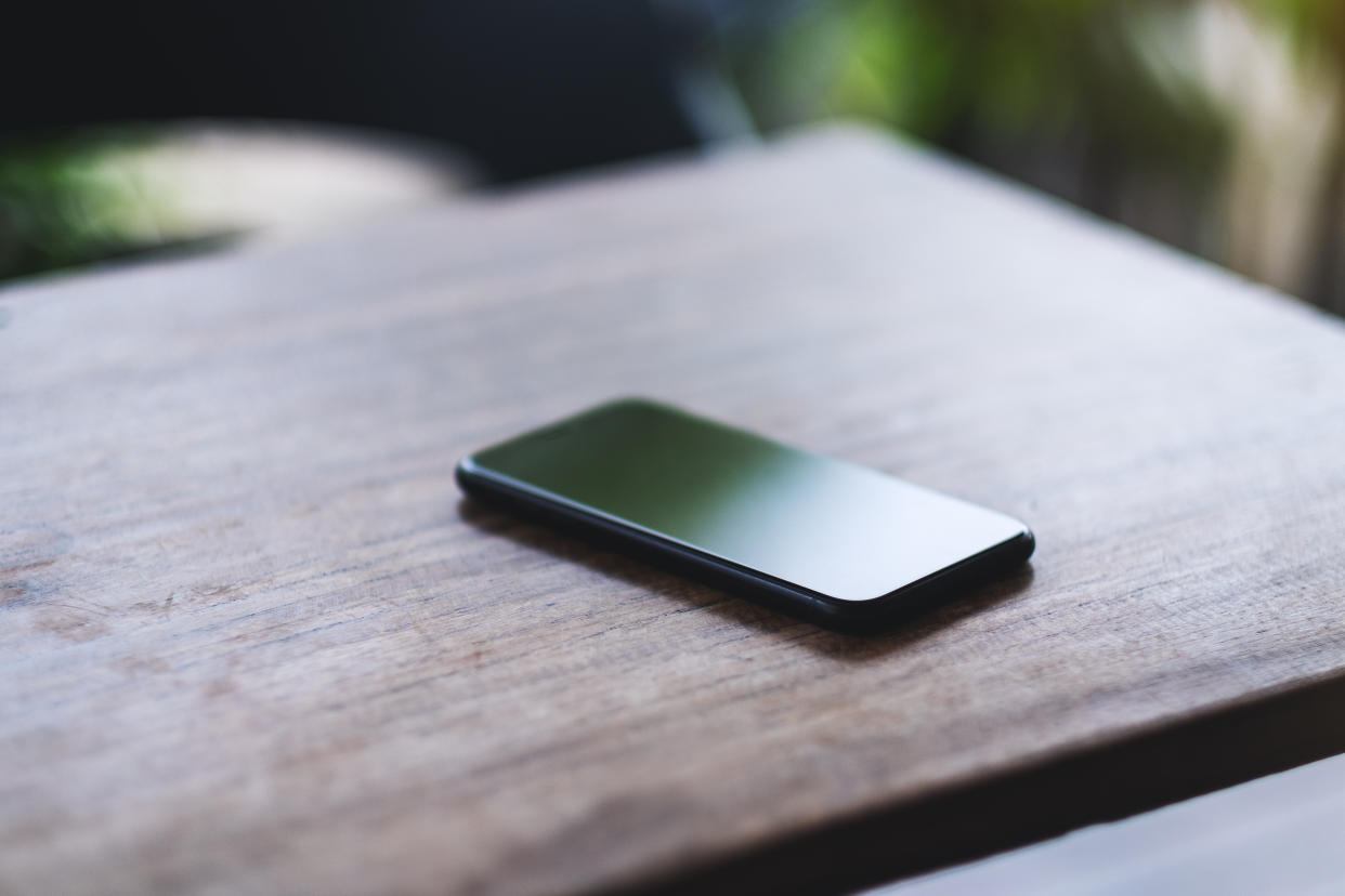 A mobile phone on wooden table 