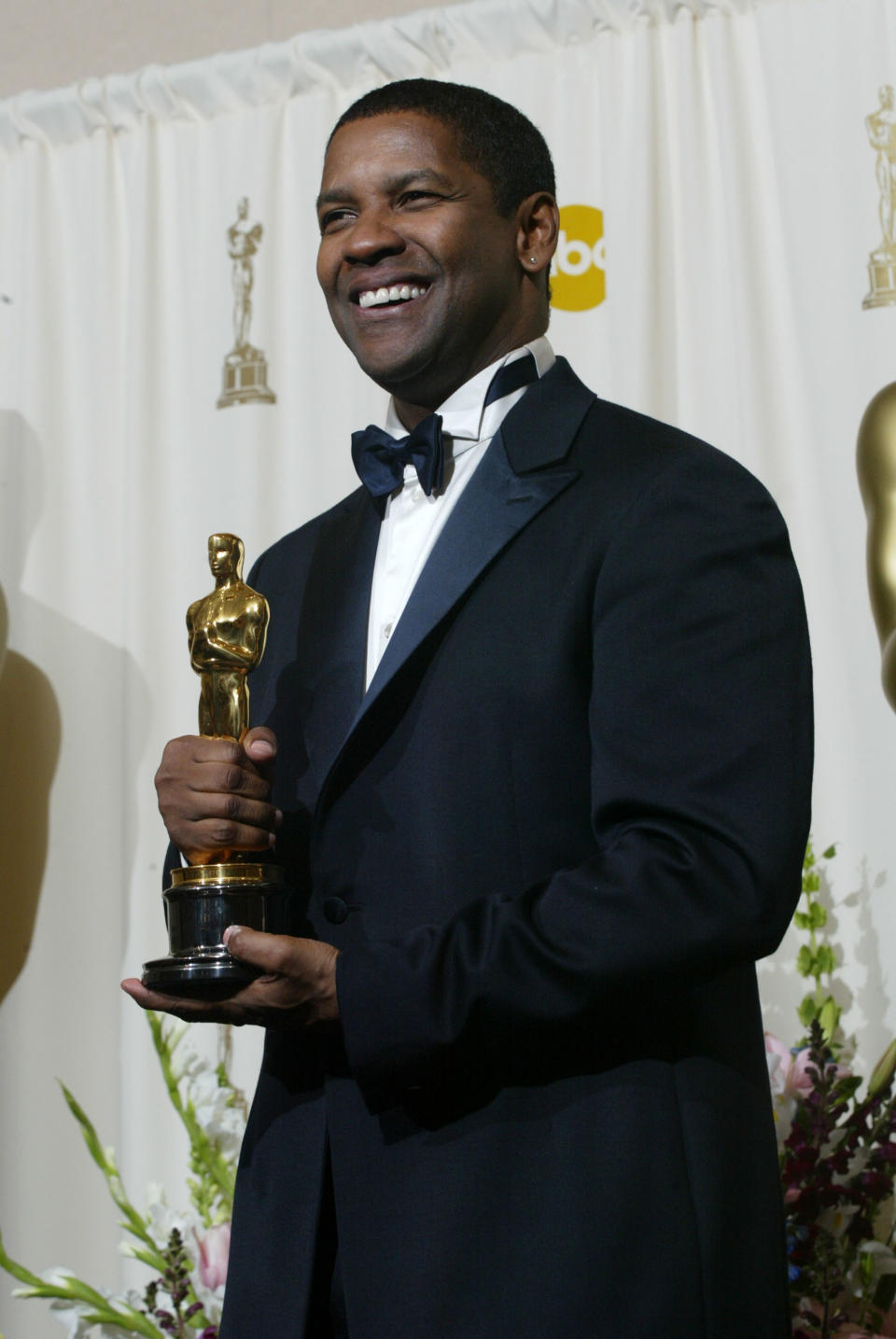 Actor Denzel Washington poses backstage with his Best Actor In A Leading Role Award for the movie Training Day during the 74th Annual Academy Awards at the Kodak Theater in Hollywood on March 24, 2002. - Credit: Frederick M. Brown/Getty Images