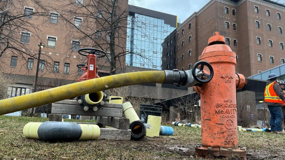 Firefighters hooked up a line from a hydrant to feed the boiler system of the QEII Halifax Infirmary complex on April 4, 2024, following a water main break.