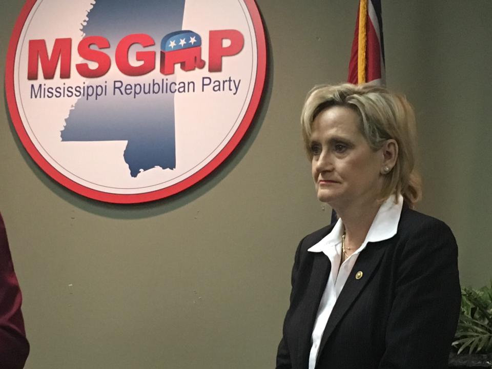 Republican U.S. Sen. Cindy Hyde-Smith of Mississippi appeared at a news conference at the state Republican Party headquarters in Jackson, Miss., on Monday, Nov. 12, 2018, and said repeatedly that she would not answer questions about a video that showed her at a Nov. 2 campaign event in Tupelo, Miss., where she praised a man by saying: "If he invited me to a public hanging, I'd be on the front row." Hyde-Smith issued a statement Sunday saying the remark was "an exaggerated expression of regard" for a friend who invited her to speak, and "any attempt to turn this into a negative connotation is ridiculous." Hyde-Smith was appointed to serve temporarily in the Senate after longtime Republican Sen. Thad Cochran retired in April, and she faces an African-American Democrat, Mike Espy, in a Nov. 27, 2018, runoff. Espy is a former congressman and former U.S. agriculture secretary. The runoff winner will serve the final two years of the six-year term started by Cochran. (AP Photo/Emily Wagster Pettus)