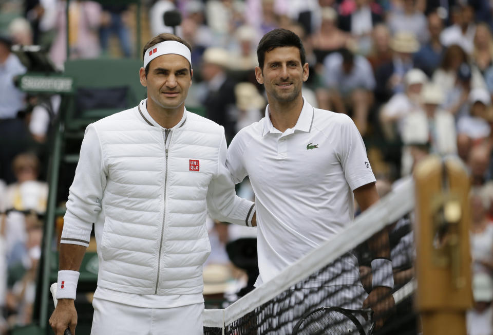 FILE - Switzerland's Roger Federer, left, and Serbia's Novak Djokovic poses before the men's singles final match of the Wimbledon Tennis Championships in London, in this Sunday, July 14, 2019, file photo. The draw to set up the singles brackets for this year’s Wimbledon will be held Friday, June 25, 2021. Play begins Monday. (AP Photo/Tim Ireland, File)