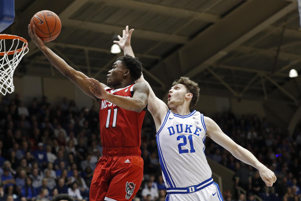 North Carolina State guard Markell Johnson (11) drives to the basket while Duke forward Matthew Hurt (21) defends during the first half of an NCAA college basketball game in Durham, N.C., Monday, March 2, 2020. (AP Photo/Gerry Broome)