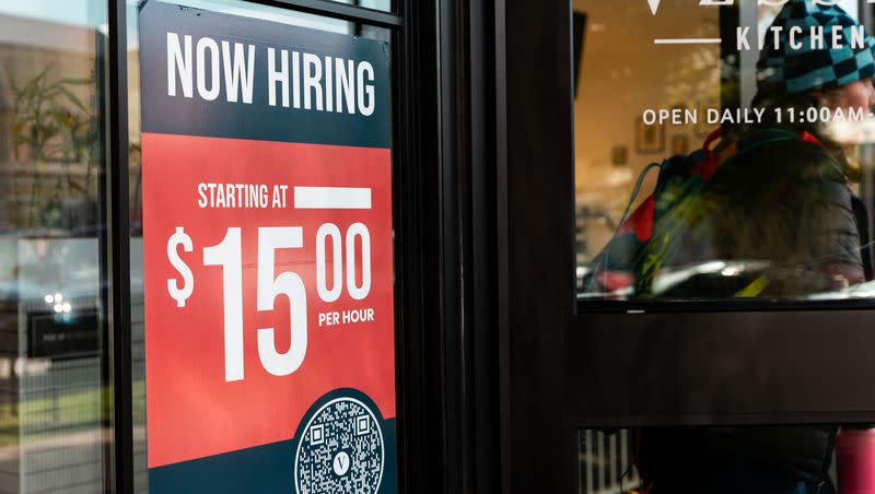 A sign reading “Now hiring” is on the window of Vessel Kitchen in Salt Lake City on Nov. 3, 2023. Utah workers are not facing as dire a challenge in finding work as many other states, a report finds.