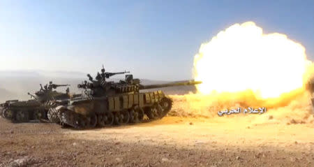 A still image taken on August 19, 2017 from a footage of Hezbollah military handout shows a Hezbollah military tank firing at western Qalamoun, Syria. Hezbollah Military Handout via Reuters TV.