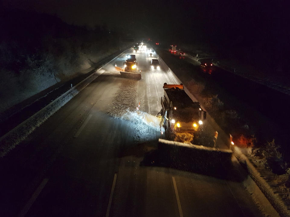 Snow ploughs clean the Autobahn A9 near Bad Klosterlausnitz, eastern Germany, Thursday, Jan. 10, 2019 after Thuringia was hit by snowfall. (Jens Henning/dpa via AP)