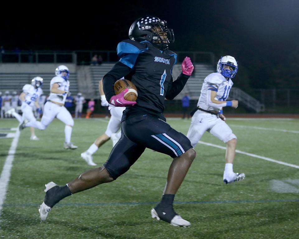 Plymouth South's Gio Lynch-Ruberio rumbles along the sideline for a sixty yard rush that found pay dirt to give Plymouth South the 7-0 lead during first quarter action of their game at Plymouth South High on Friday, Oct. 14, 2023. Scituate would go on to win 48-21.