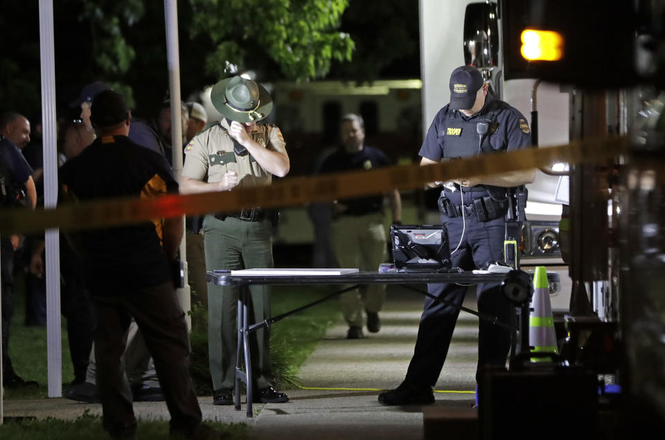 Law enforcement officials work at a command center set up at North Sumner Elementary School Saturday, April 27, 2019, in Bethpage, Tenn. Authorities in rural Tennessee captured a suspect Saturday during a manhunt that was prompted by the discovery of several bodies in two homes. (AP Photo/Mark Humphrey)