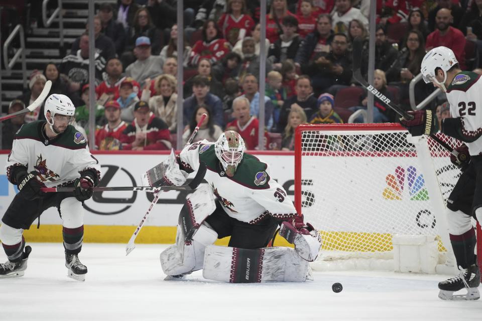 Arizona Coyotes goaltender Connor Ingram (39) deflects the puck during the second period of an NHL hockey game against the Chicago Blackhawks, Friday, Jan. 6, 2023, in Chicago. (AP Photo/Erin Hooley)