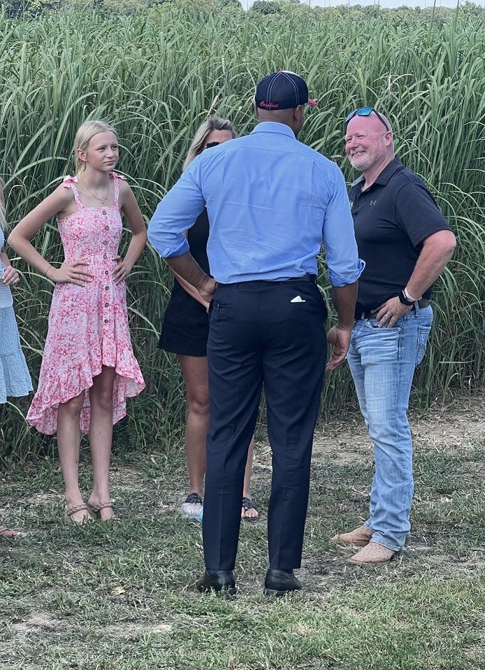 Maryland Gov. Wes Moore speaks with David Tribbett Jr., owner of Twin Maple Farms, at right, and his family, including daughter, Camdyn, left, during a visit to the Eastern Shore on June 14, 2024 in Ridgely, Md.