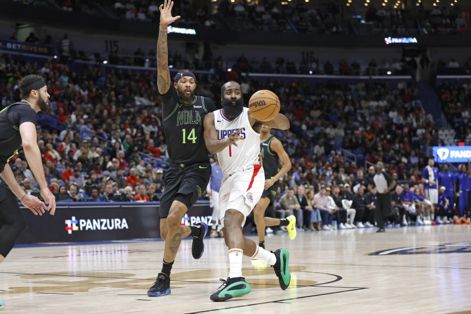Los Angeles Clippers guard James Harden (1) passes the ball in front of New Orleans Pelicans forward Brandon Ingram (14) in the first half of an NBA basketball game in New Orleans, Friday, Jan. 5, 2024. (AP Photo/Tyler Kaufman)
