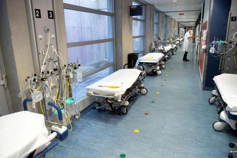 FILE PHOTO: A doctor stands in a corridor lined with hospital beds at the CHUV in Lausanne