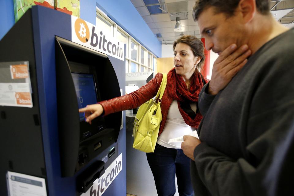 Hami Oerner and Itzik Lerner, right, learn how to use a new bitcoin ATM machine at Hacker Dojo in Mountain View, Calif., April 1, 2014. Robocoin is California's first permanent 24/7 bitcoin ATM machine. (Photo by Gary Reyes/Bay Area News Group/MCT/Sipa USA)