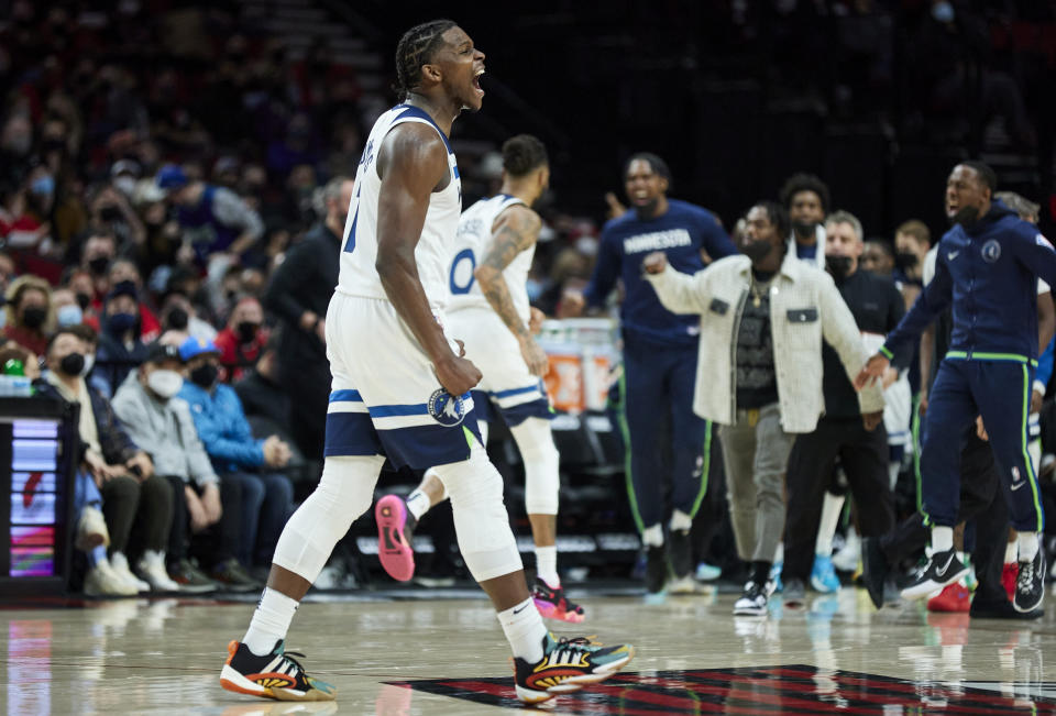 Minnesota Timberwolves forward Anthony Edwards reacts after scoring against the Portland Trail Blazers during the second half of an NBA basketball game in Portland, Ore., Tuesday, Jan. 25, 2022. (AP Photo/Craig Mitchelldyer)