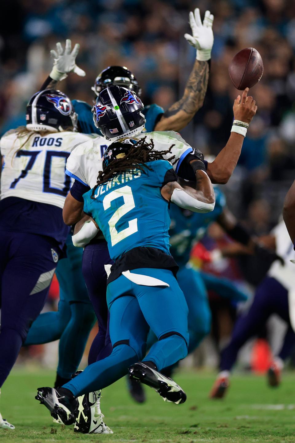 Jacksonville Jaguars safety Rayshawn Jenkins (2) forces a fumble on Tennessee Titans quarterback Joshua Dobbs (11) during the fourth quarter of an NFL football regular season matchup AFC South division title game Saturday, Jan. 7, 2023 at TIAA Bank Field in Jacksonville. The Jacksonville Jaguars held off the Tennessee Titans 20-16. [Corey Perrine/Florida Times-Union]