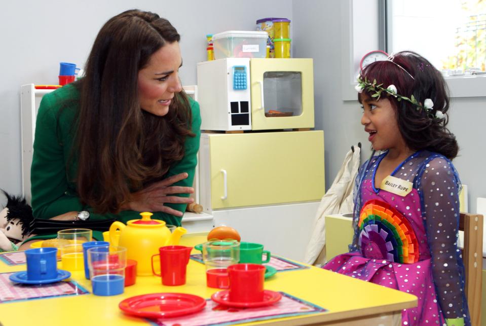 Bailey Taylor Rupe talks with Catherine, the Duchess of Cambridge, as they sit in the playroom of the Waikato Hospice in Hamilton April 12, 2014. Britain's Prince William and his wife Kate are undertaking a 19-day official visit to New Zealand and Australia with their son George. REUTERS/Peter Drury/Pool (NEW ZEALAND - Tags: ROYALS ENTERTAINMENT)