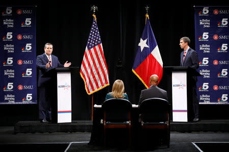 U.S. Sen. Ted Cruz (R-TX) makes a comment as Rep. Beto O'Rourke (D-TX) waits his turn during a debate for Texas U.S. Senate seat at the Southern Methodist University in Dallas, Texas, U.S., September 21, 2018. Tom Fox/The Dallas Morning News/Pool via REUTERS