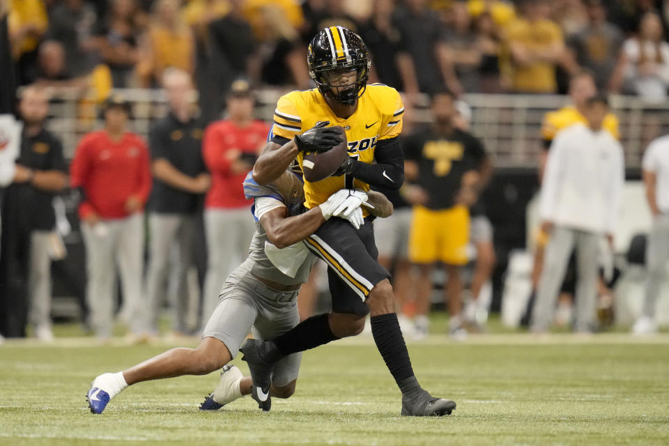 Missouri wide receiver Theo Wease Jr. (1) catches a pass as Memphis defensive back Greg Rubin defends during the first half of an NCAA college football game Saturday, Sept. 23, 2023, in St. Louis. (AP Photo/Jeff Roberson)