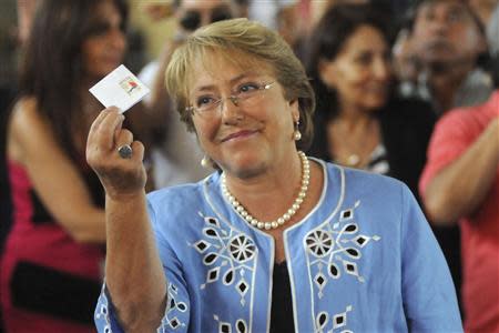 Chilean presidential candidate Michelle Bachelet shows her vote during the presidential election in Santiago December 15, 2013. REUTERS/Maglio Perez