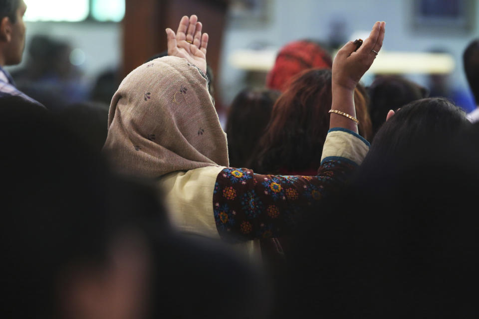 In this Sunday, Jan. 20, 2019 photo, a woman prays during Mass at St. Mary's Catholic Church in Dubai, United Arab Emirates. The Catholic Church's parishioners in the UAE come from around the world and will offer an international welcome to Pope Francis Feb. 3 through Feb. 5, that marks the first ever papal visit to the Arabian Peninsula, the birthplace of Islam. The Catholic Church believes there are some 1 million Catholics in the UAE today. (AP Photo/Jon Gambrell)