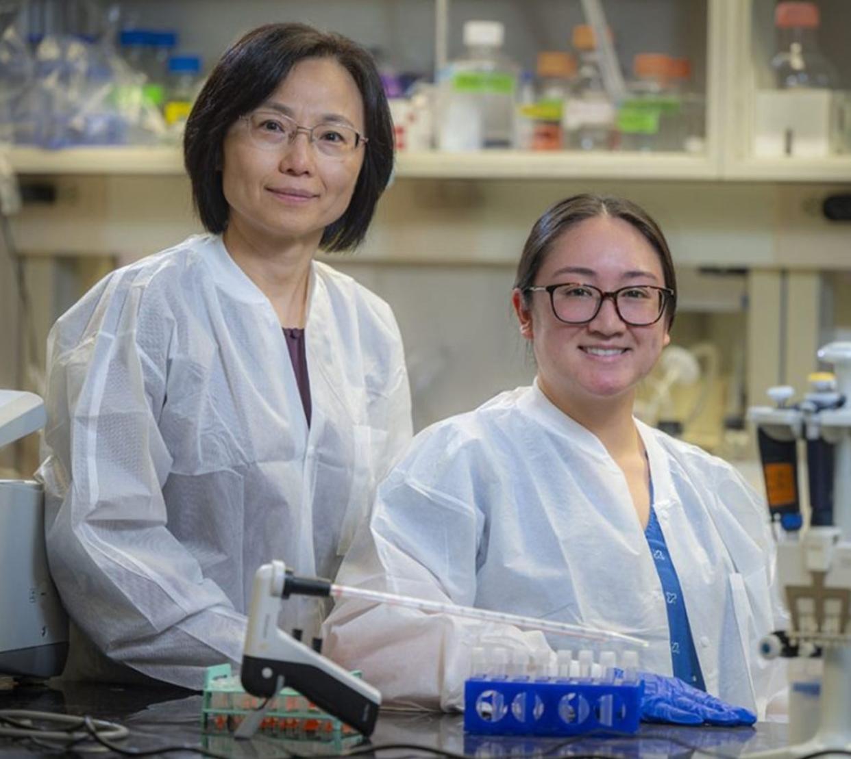 Qin Wang, MD, PhD left, and AU Graduate Student Mae Aida.