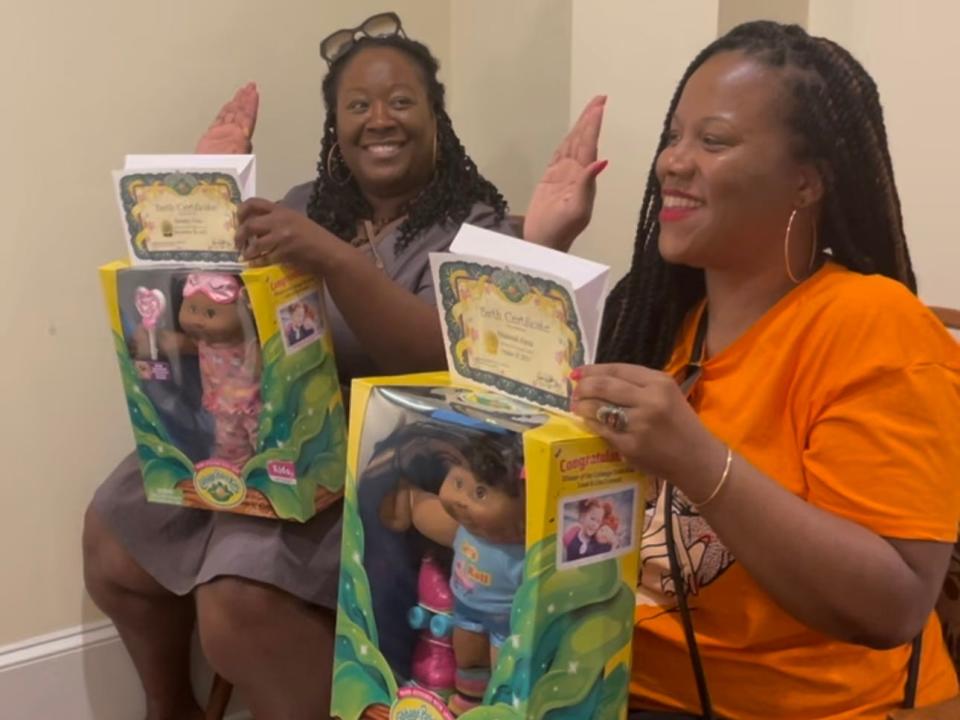 The author and her friend adopting a Cabbage Patch Doll.