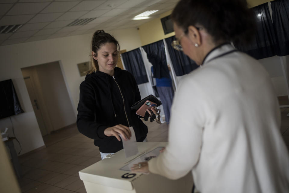 A woman casts her vote at a polling station during a referendum in Gibraltar, Thursday, June, 24, 2021. Gibraltar is holding a referendum on whether to introduce exceptions to the British territory's ban on abortion. Abortion is illegal in Gibraltar, unless it is needed to save the mother's life. Abortion is legally classified as "child destruction" and is punishable by up to life in prison. (AP Photo/Javier Fergo)