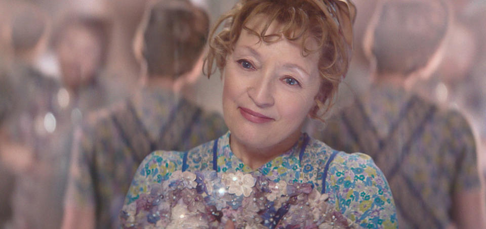 Lesley Manville as Mrs. Harris admires her boss’ Ravissante Christian Dior Haute Couture dress. - Credit: Courtesy of David Lukacs/2021 Ada Films Ltd - Harris Squared Kft