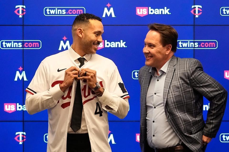 Carlos Correa alongside Twins president Derek Falvey at Target Field.