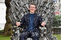 <p>Isaac Hempstead Wright takes his seat on the throne during the <em>Games of Thrones</em> Iron Throne unveiling, celebrating the 10-year anniversary of the show, on June 22 in Leicester Square, London.</p>