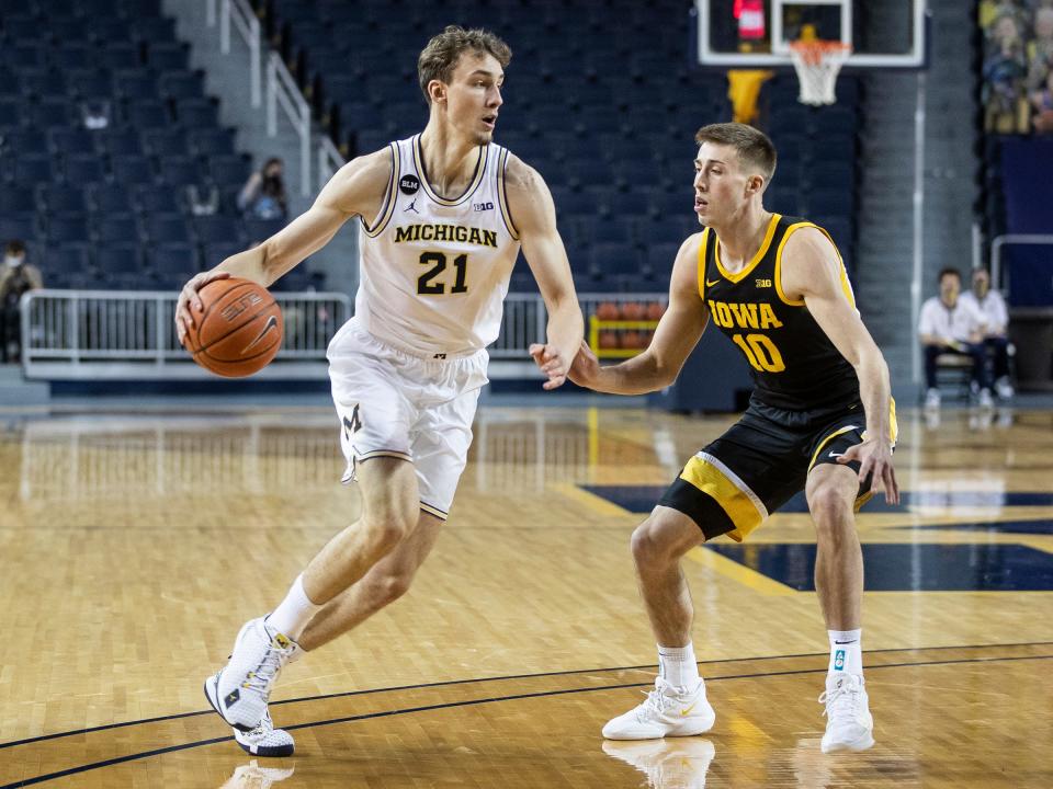 Michigan guard Franz Wagner dribbles against Iowa guard Joe Wieskamp during the first half at Crisler Center in Ann Arbor, Thursday, Feb. 25, 2021.