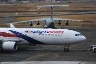 A Malaysia Airlines plane (below) on the runway at Perth International Airport, on March 25, 2014