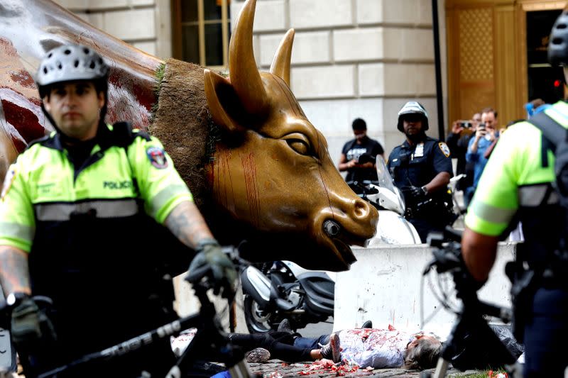 FILE PHOTO: Climate change activists protest at the Wall Street Bull in Lower Manhattan during Extinction Rebellion protests in New York City