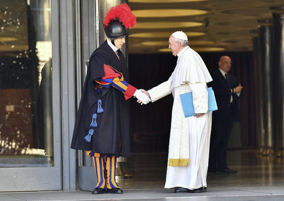 Pope Francis greets a Vatican Swiss guard as he arrives for the opening of a sex abuse prevention summit, at the Vatican, Thursday, Feb. 21, 2019. The gathering of church leaders from around the globe is taking place amid intense scrutiny of the Catholic Church's record after new allegations of abuse and cover-up last year sparked a credibility crisis for the hierarchy. (Vincenzo Pinto/Pool Photo via AP)